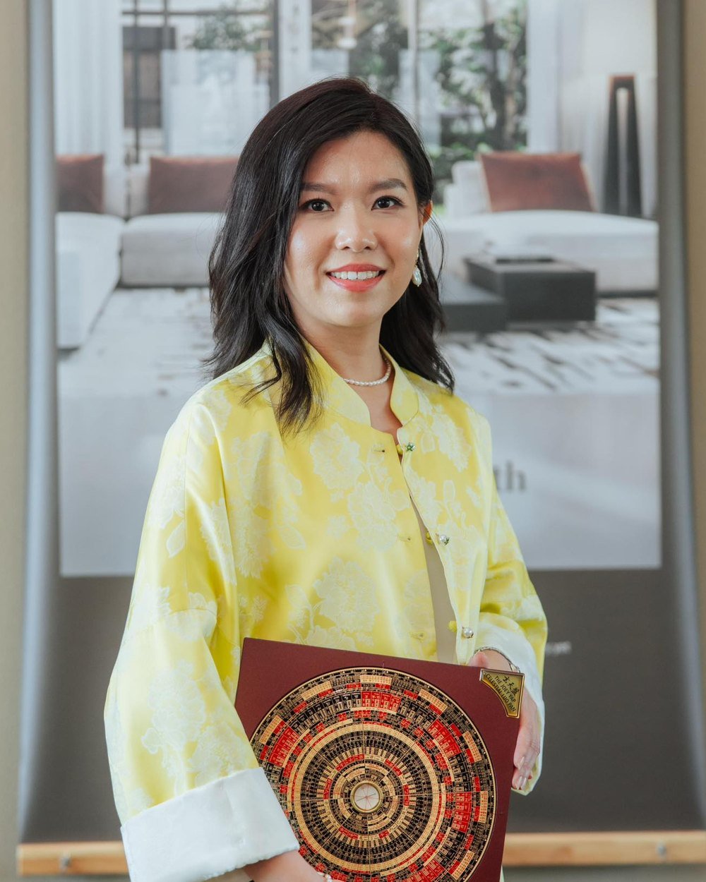 YT Consultancy founder holding a Feng Shui luopan compass